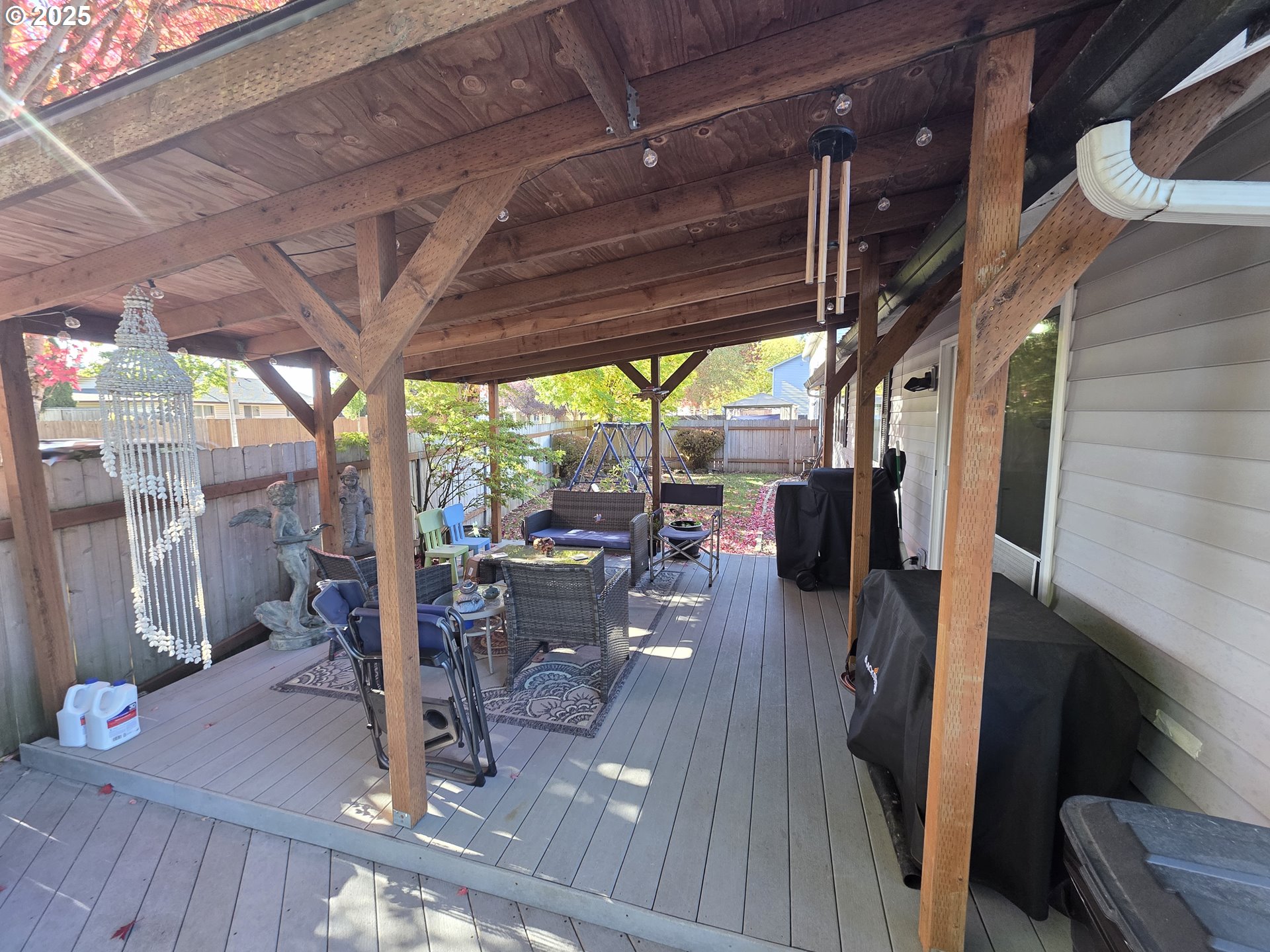 413 Southeast 8th Street Battle Ground, WA 98604 - Photo 5 of 18 a view of a patio with table and chairs and wooden floor