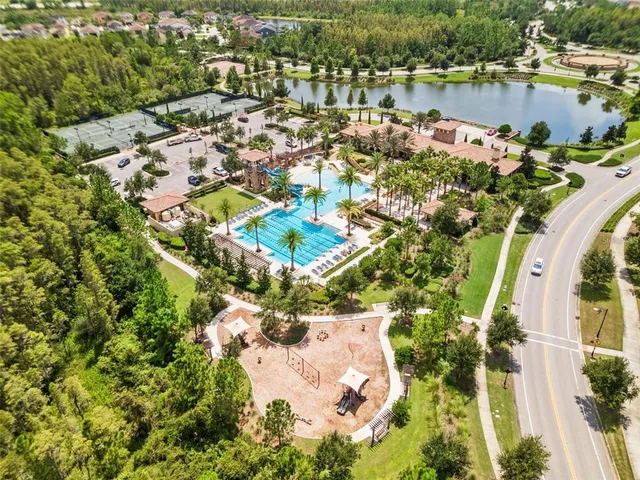 an aerial view of residential houses with outdoor space and lake view