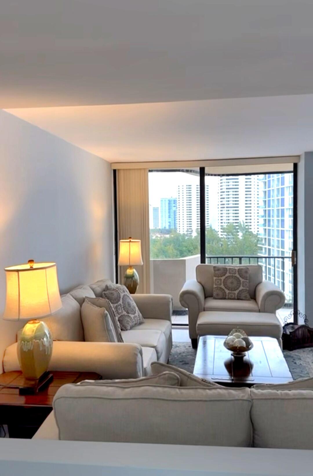 4200 North Ocean Drive, Unit 21201 Riviera Beach, FL 33404 - Photo 7 of 7 a living room with furniture and a large window