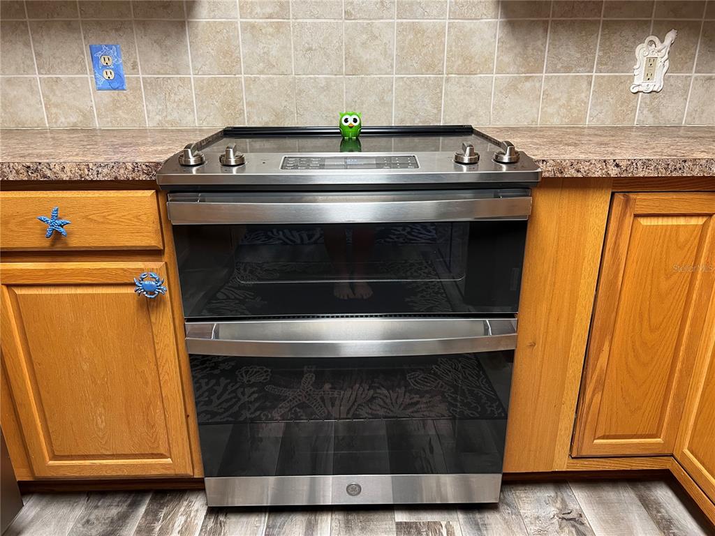 11375 Corrigan Street Spring Hill, FL 34609 - Photo 13 of 36 a view of a sink with wooden cabinets