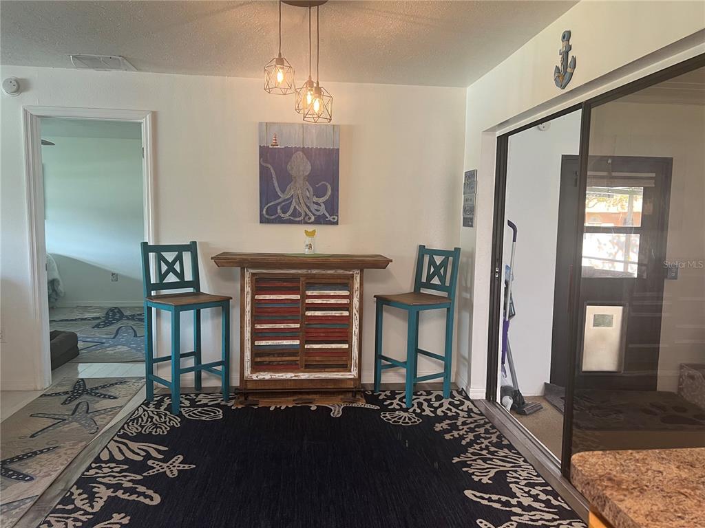 11375 Corrigan Street Spring Hill, FL 34609 - Photo 14 of 36 a view of a livingroom with wooden floor and a chandelier