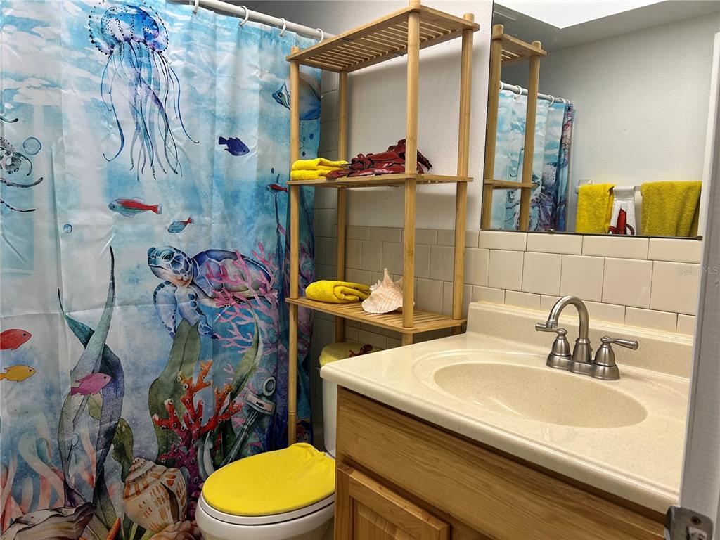 11375 Corrigan Street Spring Hill, FL 34609 - Photo 17 of 36 a bathroom with a sink mirror vanity and toilet