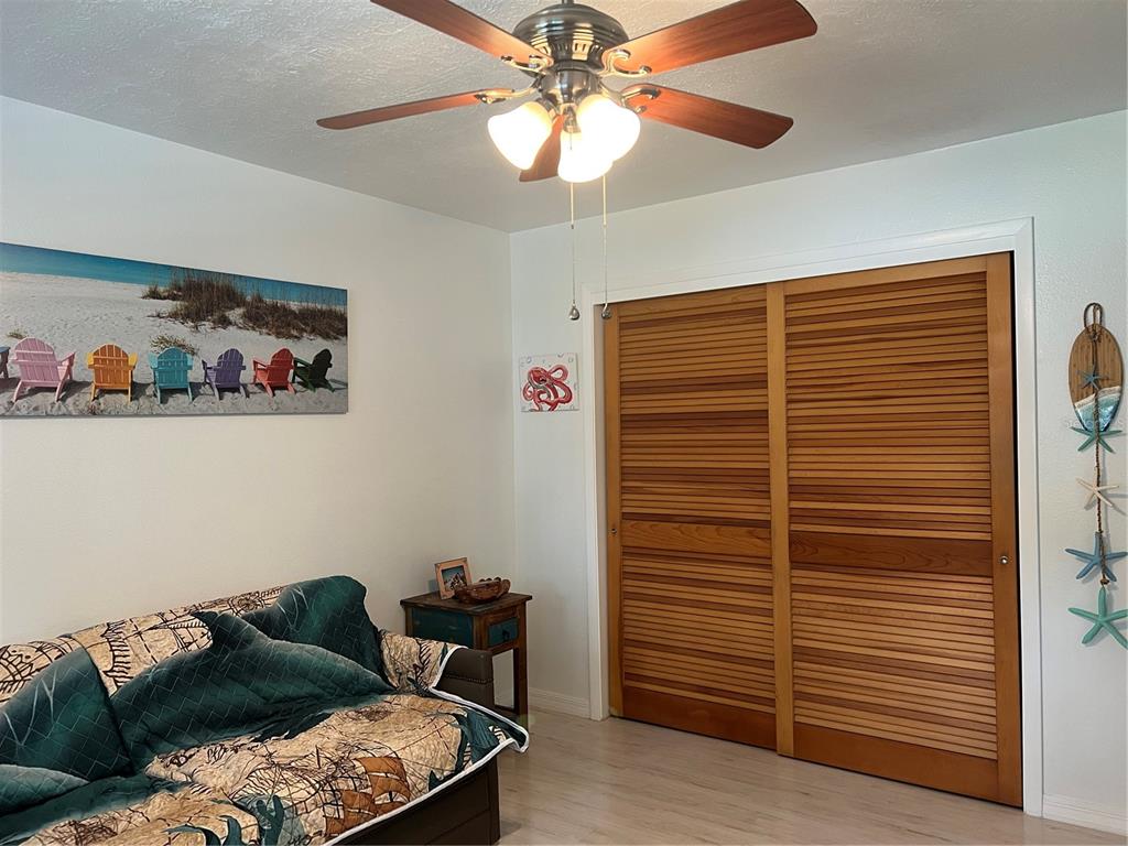 11375 Corrigan Street Spring Hill, FL 34609 - Photo 18 of 36 a living room with furniture and a walk in closet