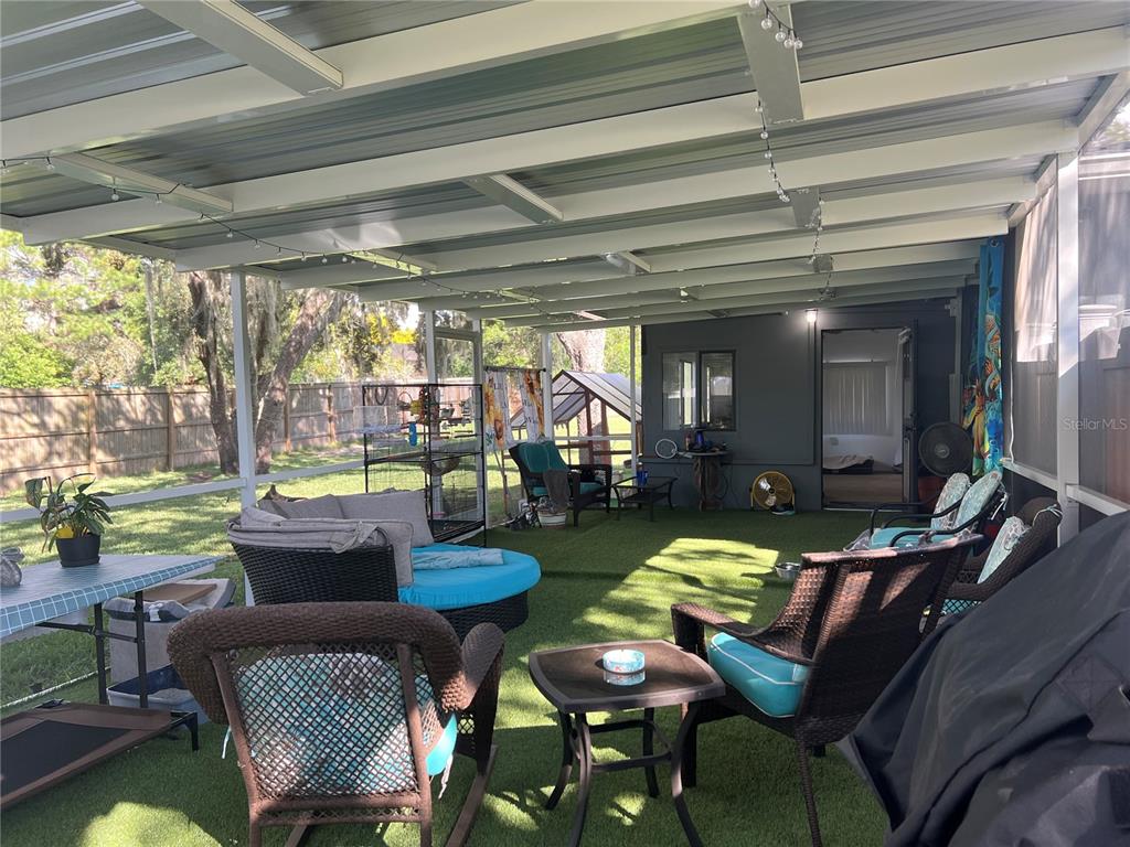 11375 Corrigan Street Spring Hill, FL 34609 - Photo 24 of 36 a living room with furniture and a floor to ceiling window