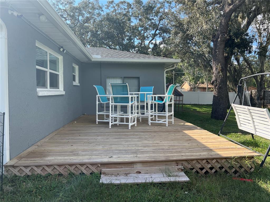 11375 Corrigan Street Spring Hill, FL 34609 - Photo 32 of 36 a wooden bench sitting in middle of a yard