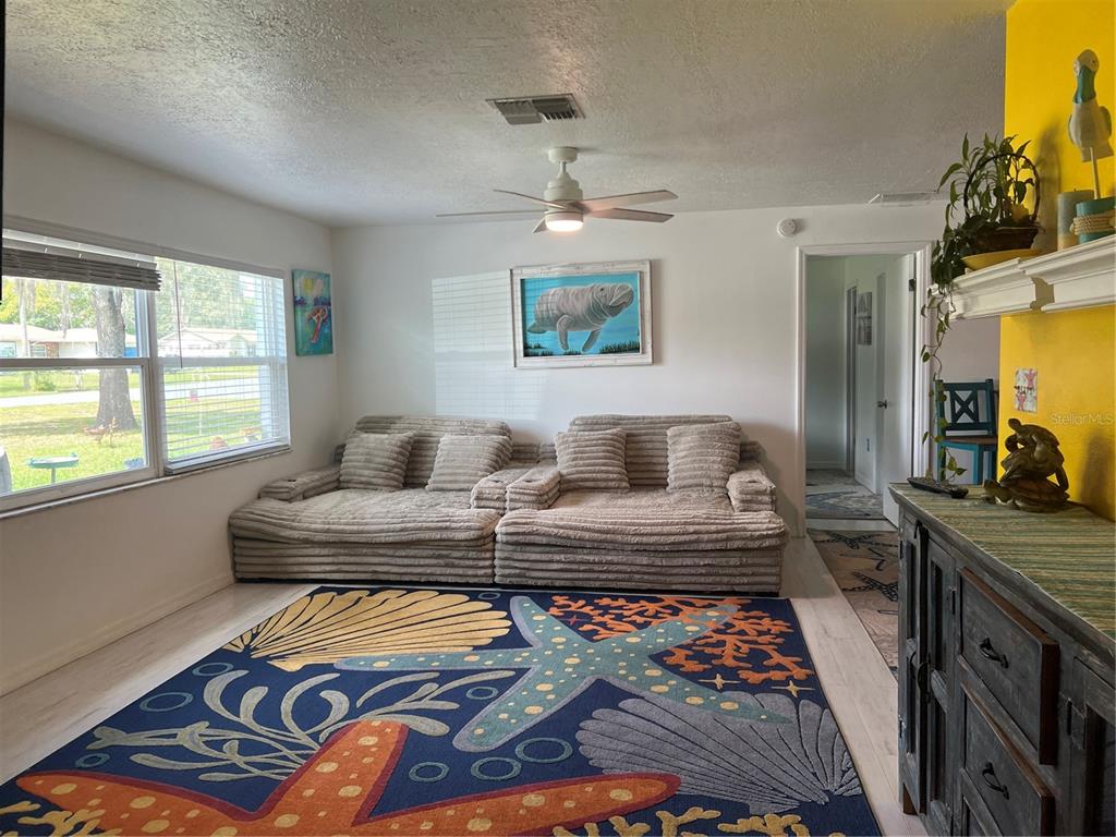 11375 Corrigan Street Spring Hill, FL 34609 - Photo 6 of 36 a bedroom with furniture and a rug