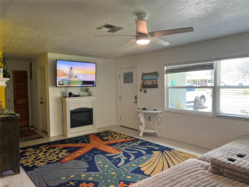 11375 Corrigan Street Spring Hill, FL 34609 - Photo 8 of 36 a living room with furniture and a fireplace