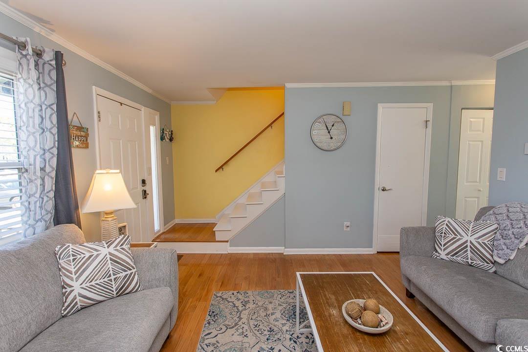 4115 Little River Road, Unit 4F Myrtle Beach, SC 29577 - Photo 5 of 38 Living area featuring ornamental molding, stairway
