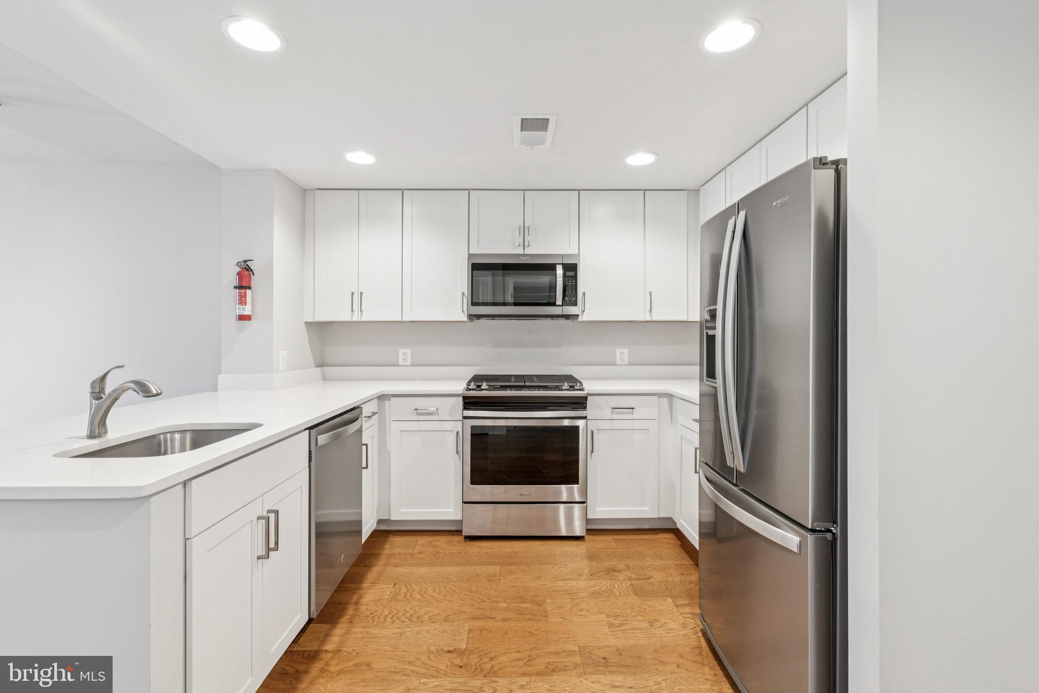 50 Florida Avenue Northeast, Unit 310 Washington, DC 20002 - Photo 5 of 18 a kitchen with stainless steel appliances granite countertop a refrigerator sink and microwave