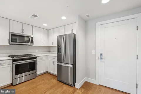 a kitchen with a refrigerator stove and microwave