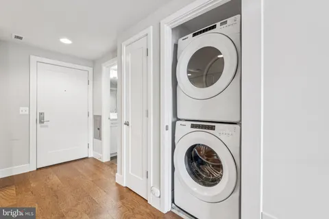 a view of a hallway with washer and dryer
