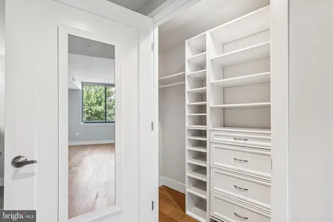 a view of walk in closet with empty racks
