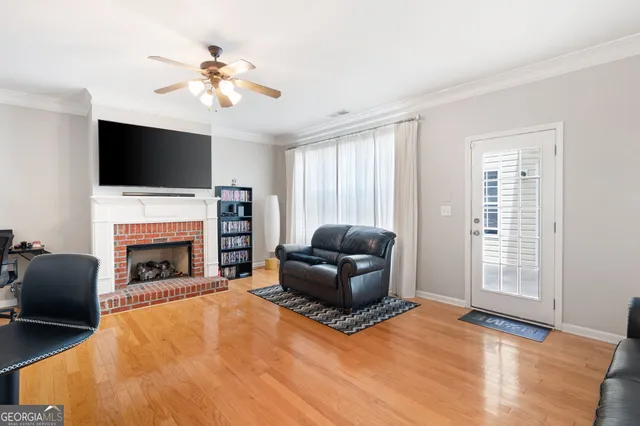 a living room with furniture a fireplace and a flat screen tv