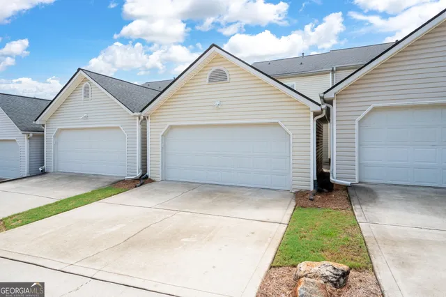 a view of a pathway with a house in the background