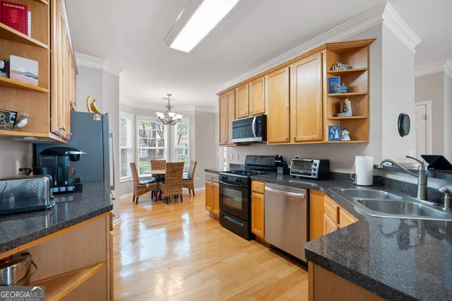 a kitchen with stainless steel appliances granite countertop a refrigerator sink and cabinets