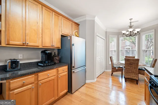 a kitchen with stainless steel appliances kitchen island granite countertop a stove a sink and a microwave