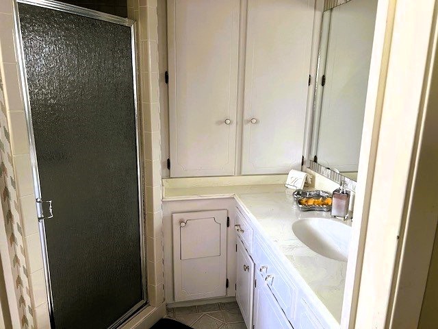 8639 Cedarbrake Drive Spring Valley Village, TX 77055 - Photo 12 of 26 Experience the charm of this primary bathroom featuring a sleek single shower, elegant single sink, and convenient built-in cabinets for effortless storage.