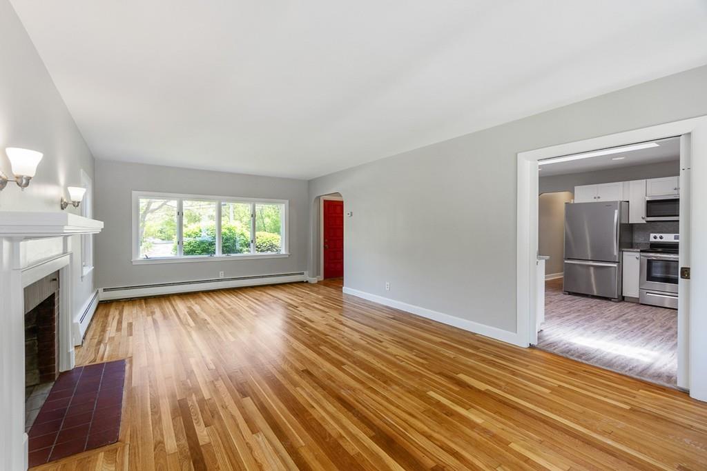 115 Mill Street Lincoln, MA 01773 - Photo 3 of 16 wooden floor in an empty room with a fireplace