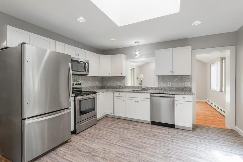 115 Mill Street Lincoln, MA 01773 - Photo 4 of 16 a kitchen with stainless steel appliances a refrigerator sink and microwave