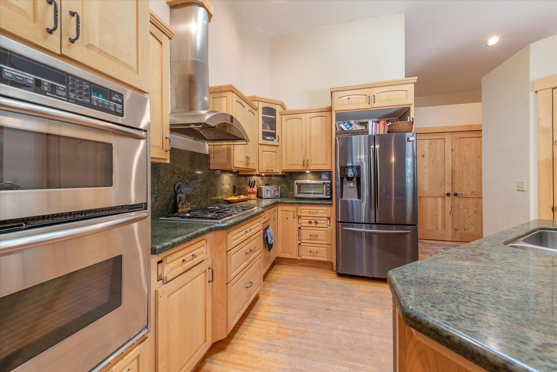 11013 Beacon Road Truckee, CA 96161 - Photo 12 of 20 a kitchen with stainless steel appliances granite countertop a refrigerator sink and stove
