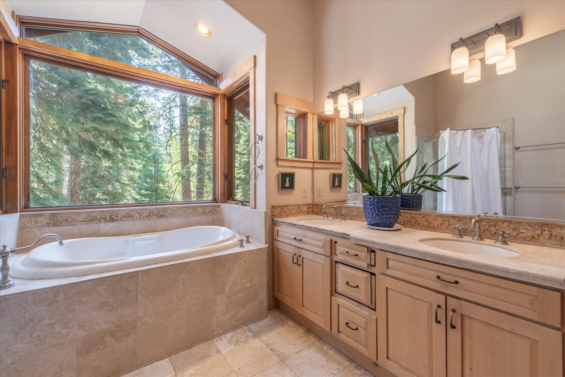 11013 Beacon Road Truckee, CA 96161 - Photo 14 of 20 a spacious bathroom with a granite countertop sink and a large mirror