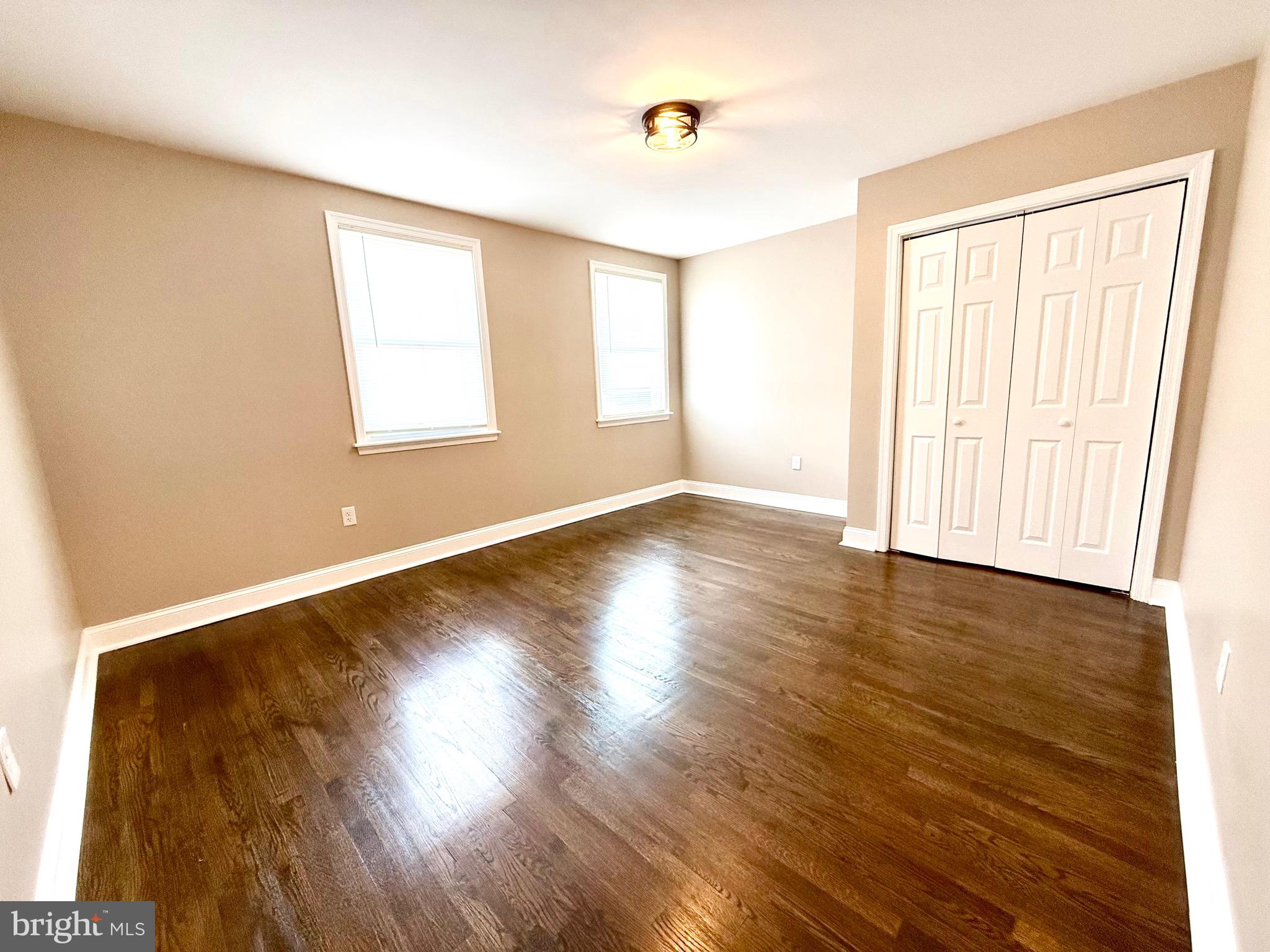 8103 Gray Haven Road Baltimore, MD 21222 - Photo 11 of 14 a view of an empty room with wooden floor and a window