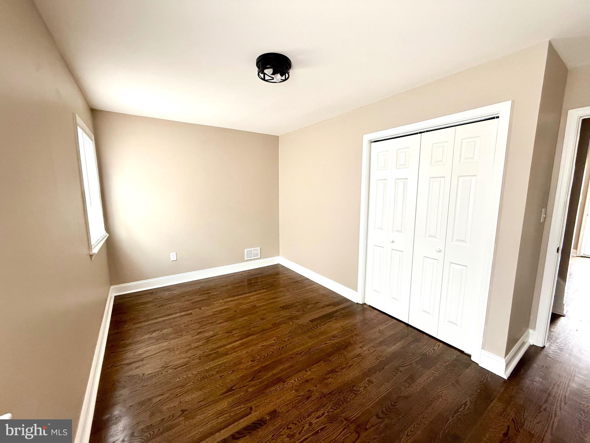 8103 Gray Haven Road Baltimore, MD 21222 - Photo 5 of 14 wooden floor in an empty room with a window