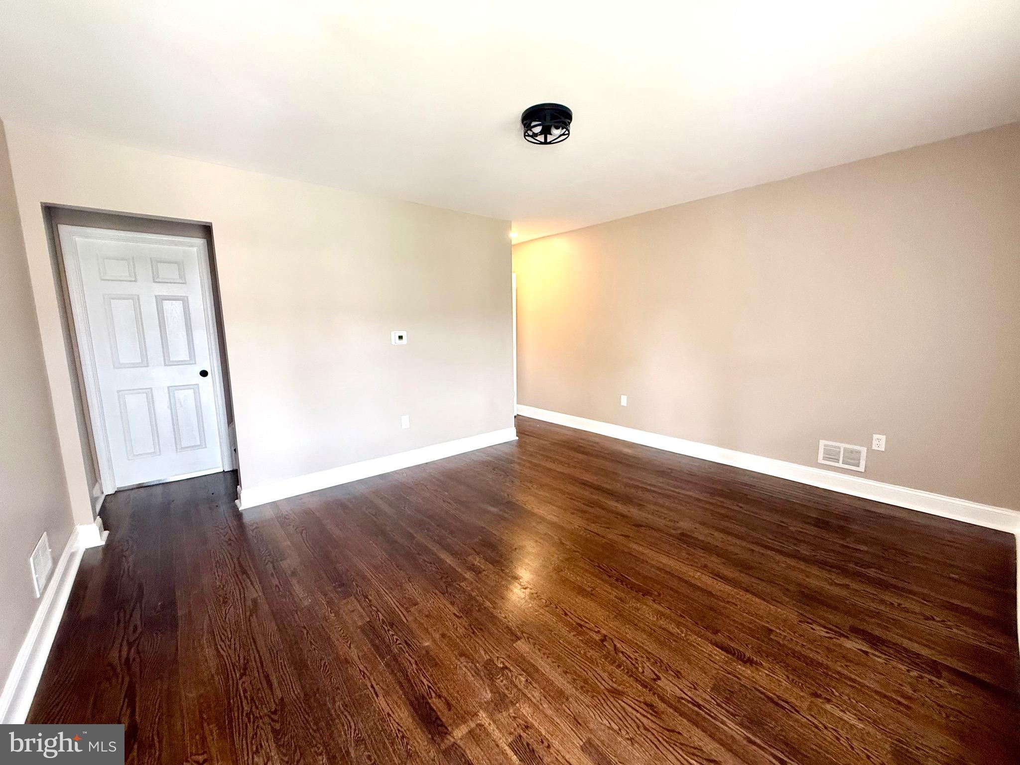 8103 Gray Haven Road Baltimore, MD 21222 - Photo 6 of 14 a view of an empty room with wooden floor