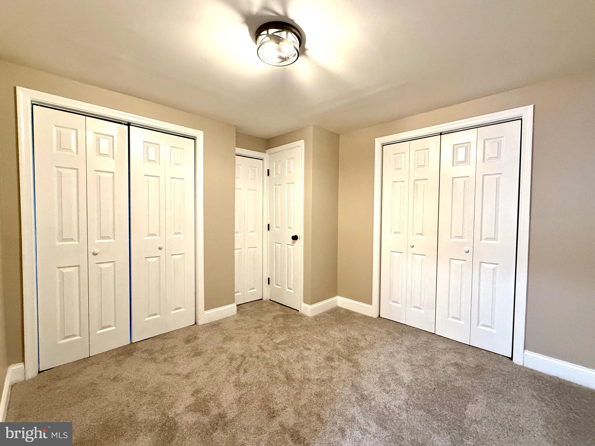 8103 Gray Haven Road Baltimore, MD 21222 - Photo 8 of 14 an empty room with windows and closet