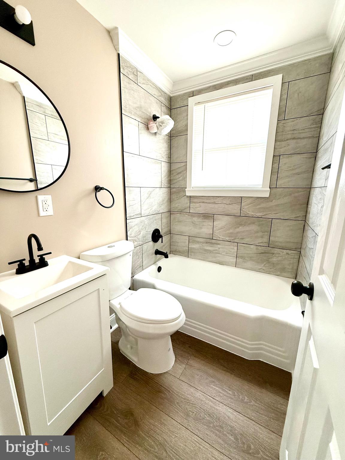 8103 Gray Haven Road Baltimore, MD 21222 - Photo 9 of 14 a bathroom with a sink a toilet and a bathtub