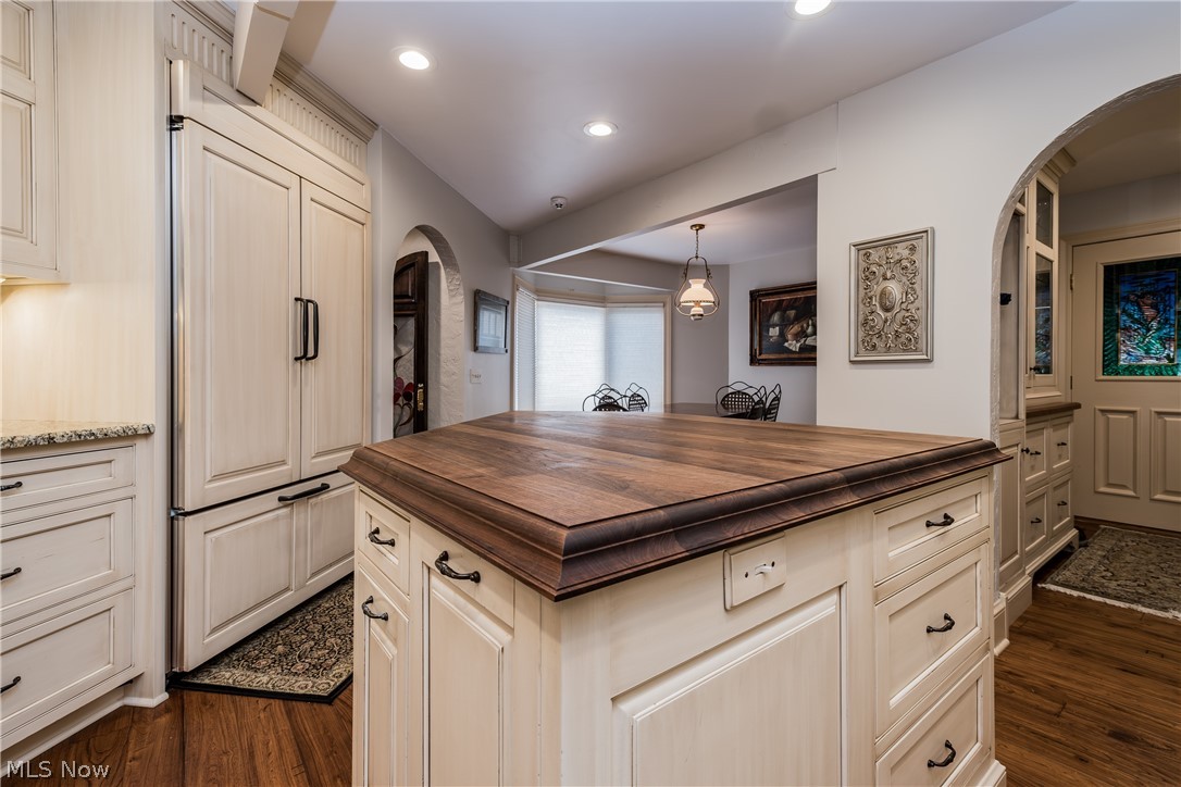 1415 Harbor Drive Northwest Canton, OH 44708 - Photo 11 of 46 Kitchen featuring butcher block counters, a kitchen island, paneled built in refrigerator/freezer, and dark hardwood / wood-style flooring