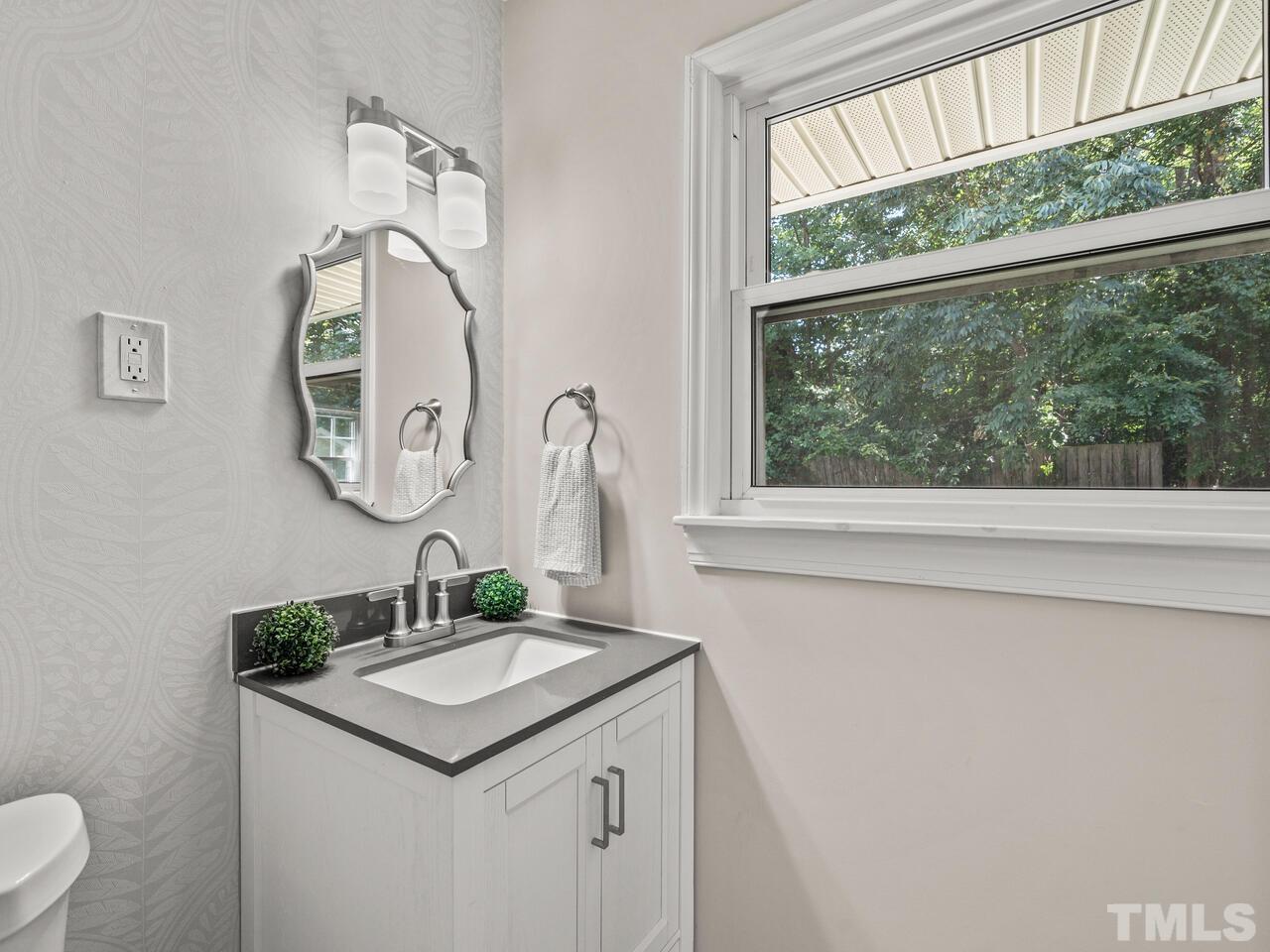 430 Obie Drive Durham, NC 27713 - Photo 24 of 35 a bathroom with a sink and a mirror