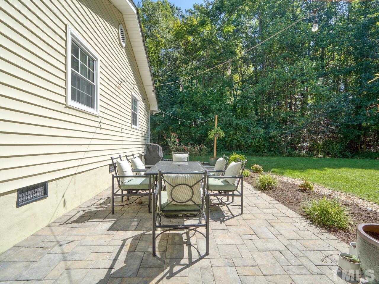 430 Obie Drive Durham, NC 27713 - Photo 30 of 35 a view of a patio with a table and chairs next to a yard