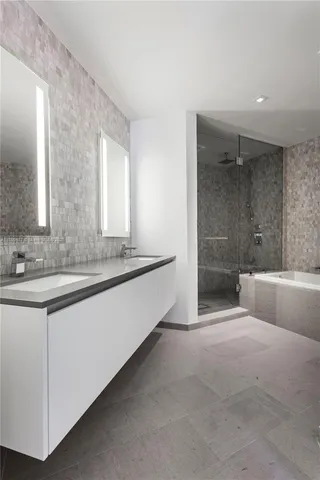 a spacious bathroom with a bathtub and a sink