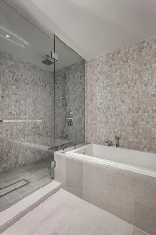 a bathroom with a bathtub and a shower