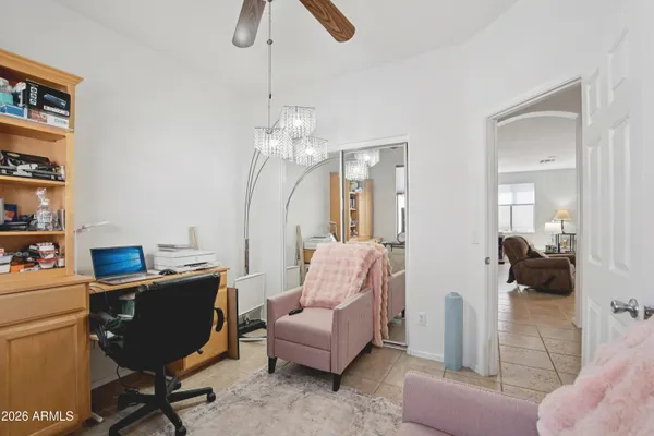 a view of a livingroom with workspace and a window