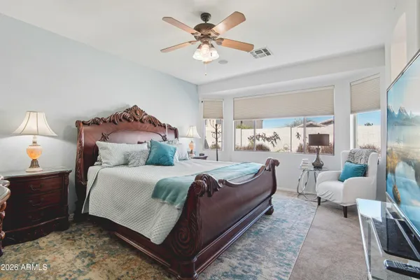 a room with a bed and a mirror on dresser