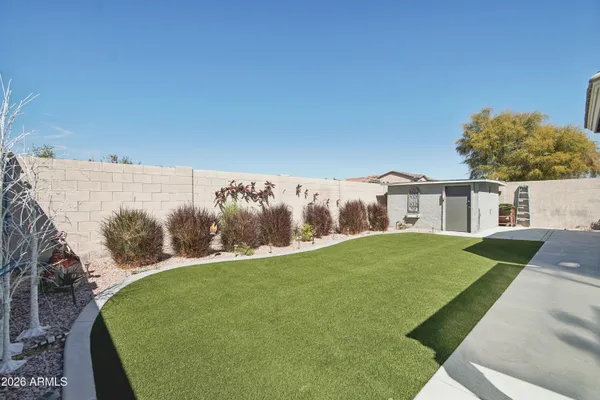 a view of a house with pool and a yard