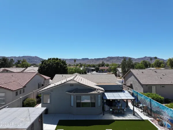 an aerial view of a house with a yard