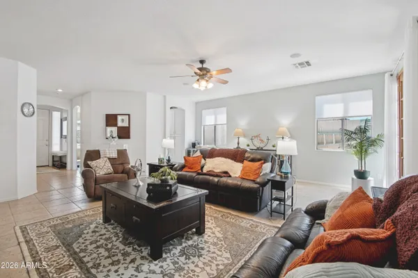 a living room with furniture ceiling fan and a rug