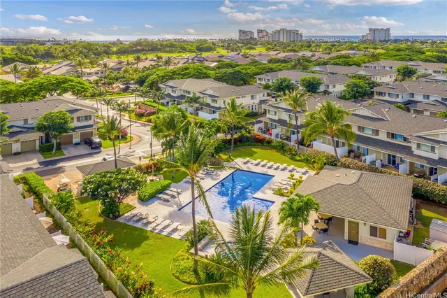 an aerial view of residential houses with outdoor space and swimming pool