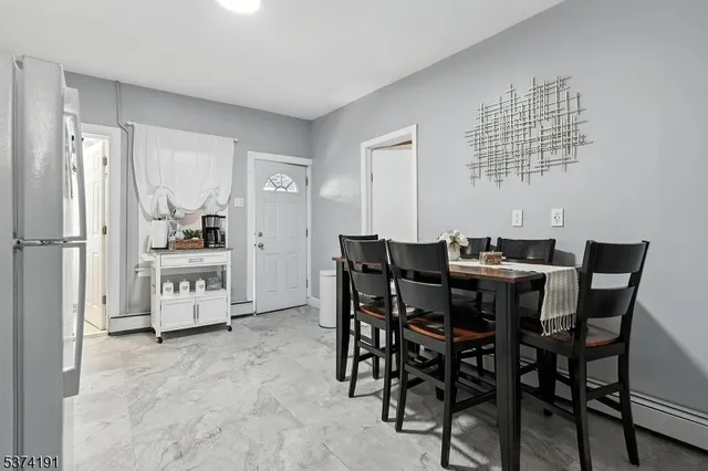 a view of a dining room with furniture and chandelier