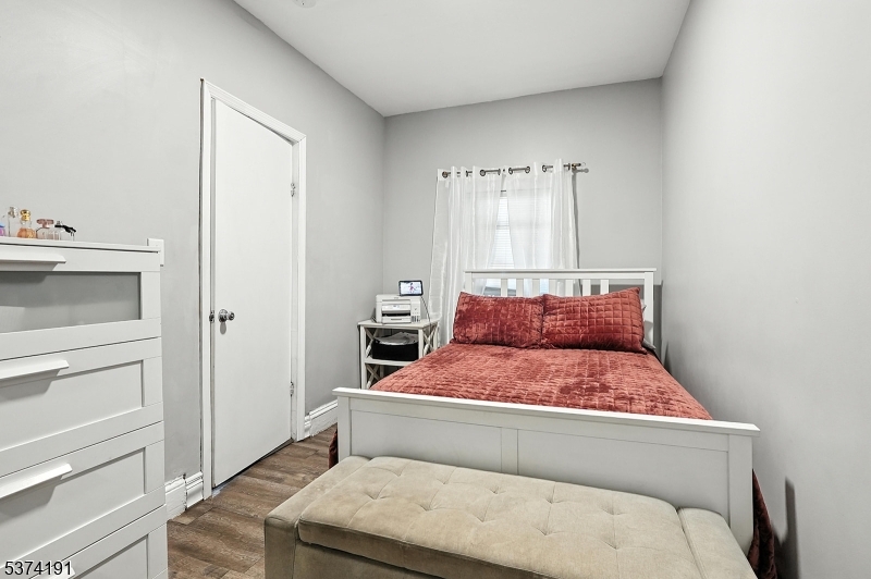 50 Oak Street Paterson, NJ 07501 - Photo 15 of 28 a bedroom with a bed and a window