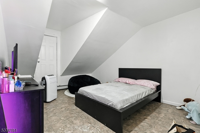 50 Oak Street Paterson, NJ 07501 - Photo 16 of 28 a bedroom with bed and a large window