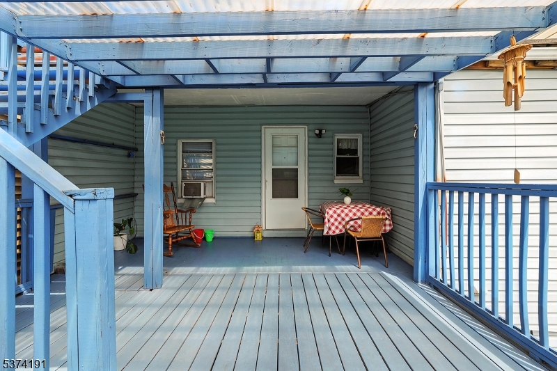 50 Oak Street Paterson, NJ 07501 - Photo 20 of 28 a view of a patio with table and chairs with wooden floor and fence