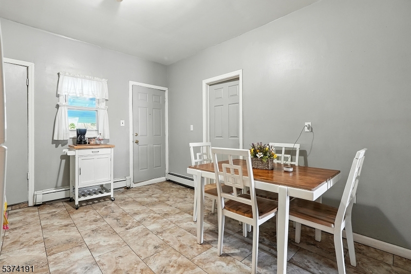 50 Oak Street Paterson, NJ 07501 - Photo 7 of 28 a dining room with furniture and a kitchen view