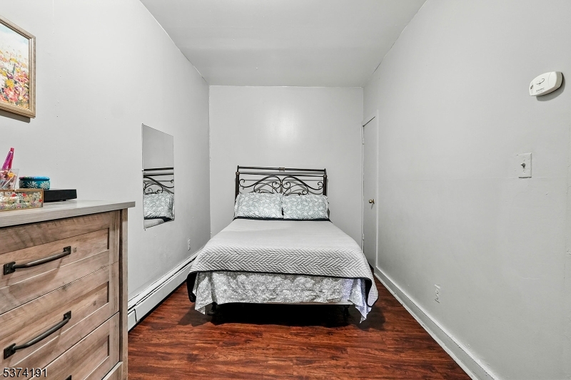 50 Oak Street Paterson, NJ 07501 - Photo 8 of 28 a bedroom with a bed and window