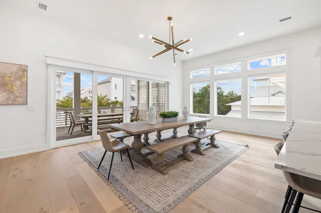 a living room with furniture a flat screen tv and kitchen view