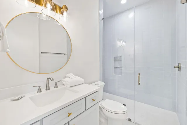 a view of a hallway with wooden floor and a living room
