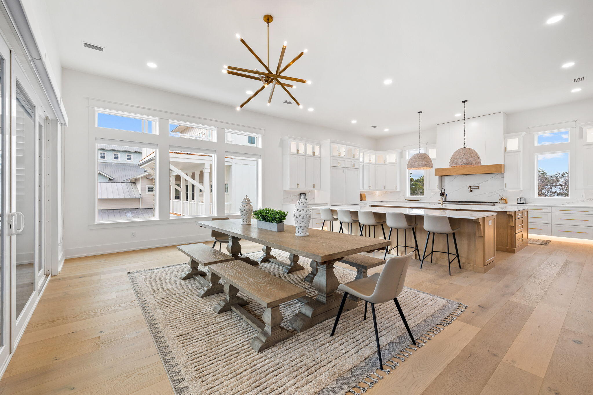 311 Walton Rose Ln Inlet Beach Inlet Beach, FL 32461 - Photo 9 of 90 a dining room with stainless steel appliances kitchen island granite countertop a stove a sink a dining table and chairs with wooden floor
